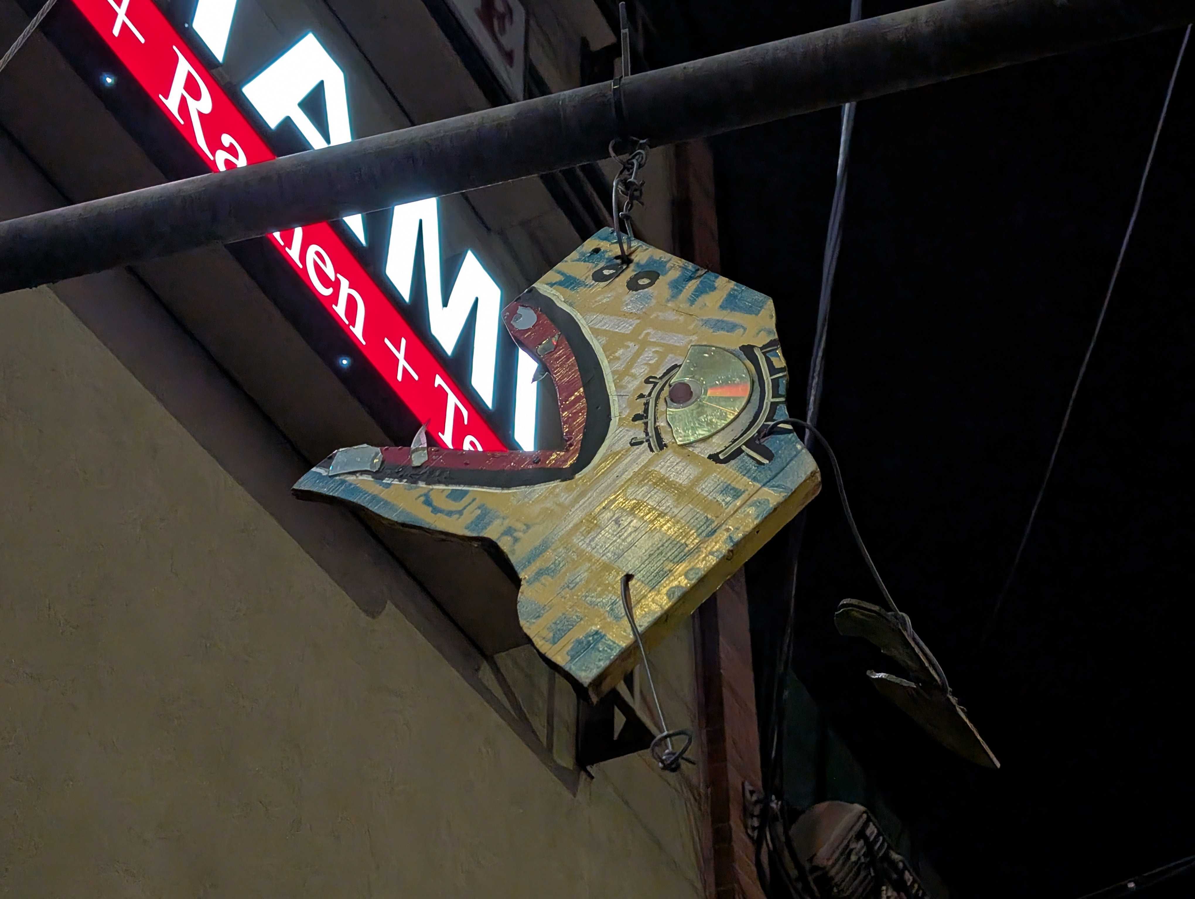 A piece of art hanging from a pole at night