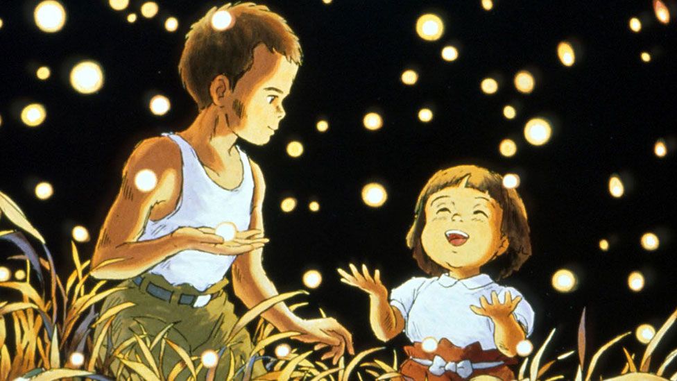 Two siblings surrounded by fireflies