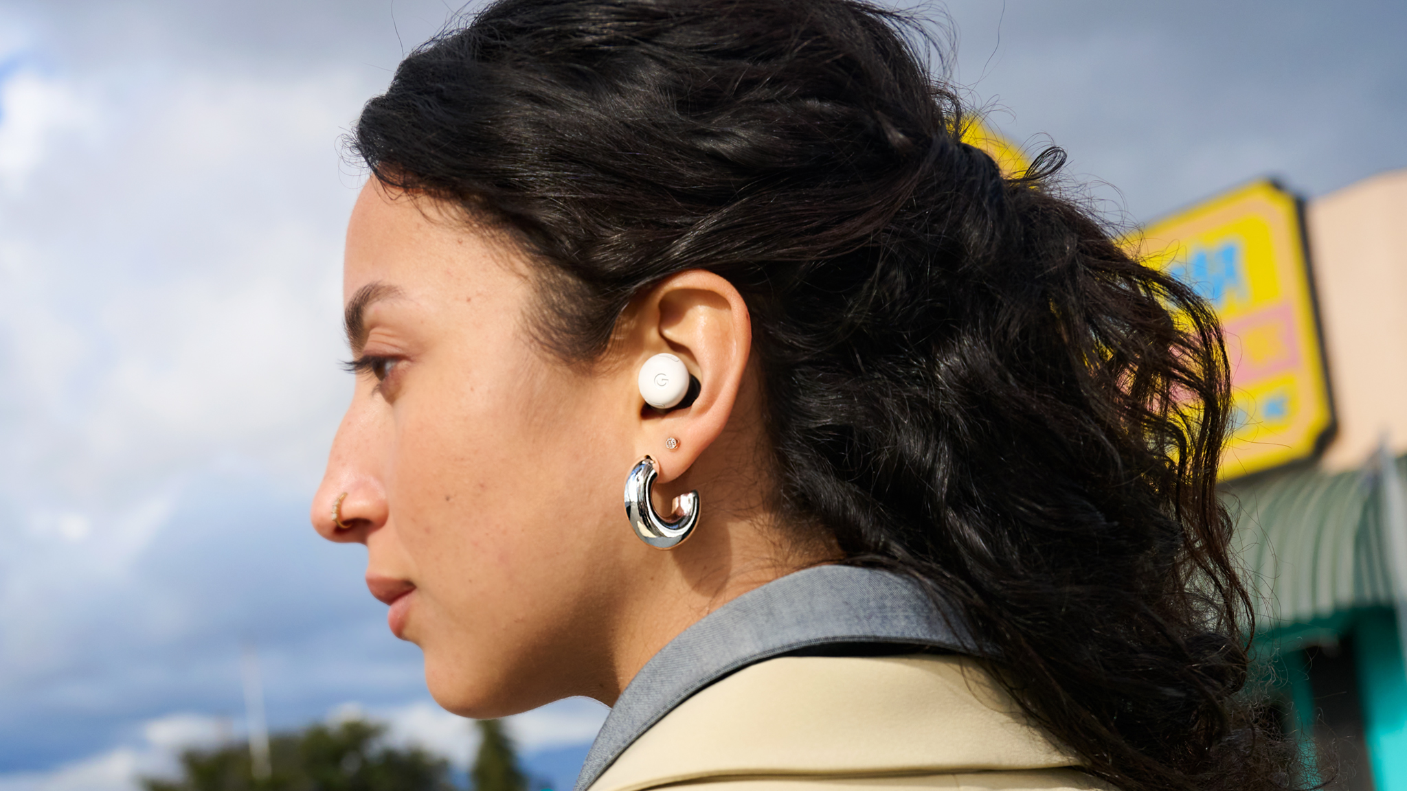 Woman wearing Google Pixel Buds Pro 2 earbuds.