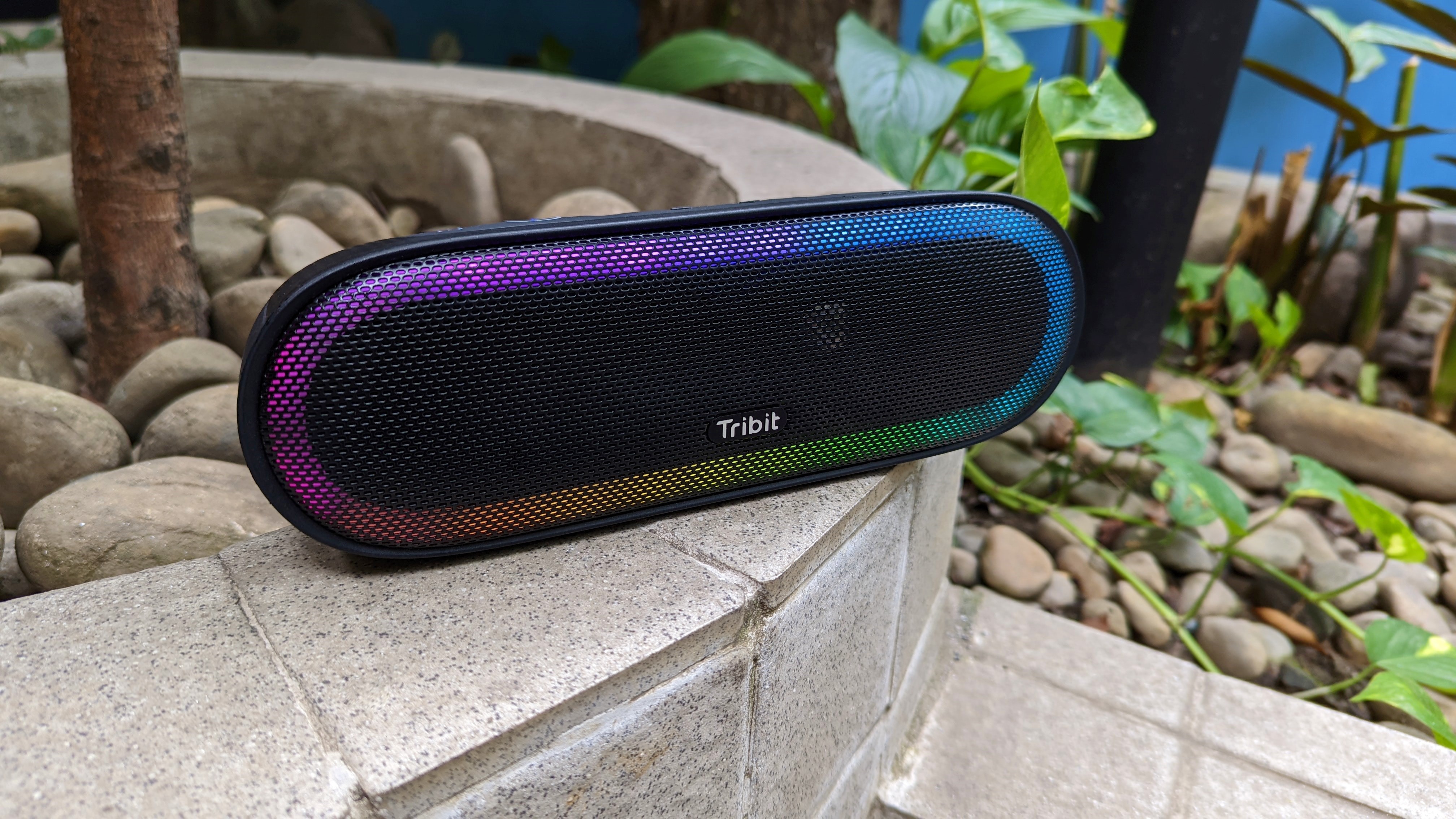 Tribit XSound Mega speaker outdoors on a stone structure