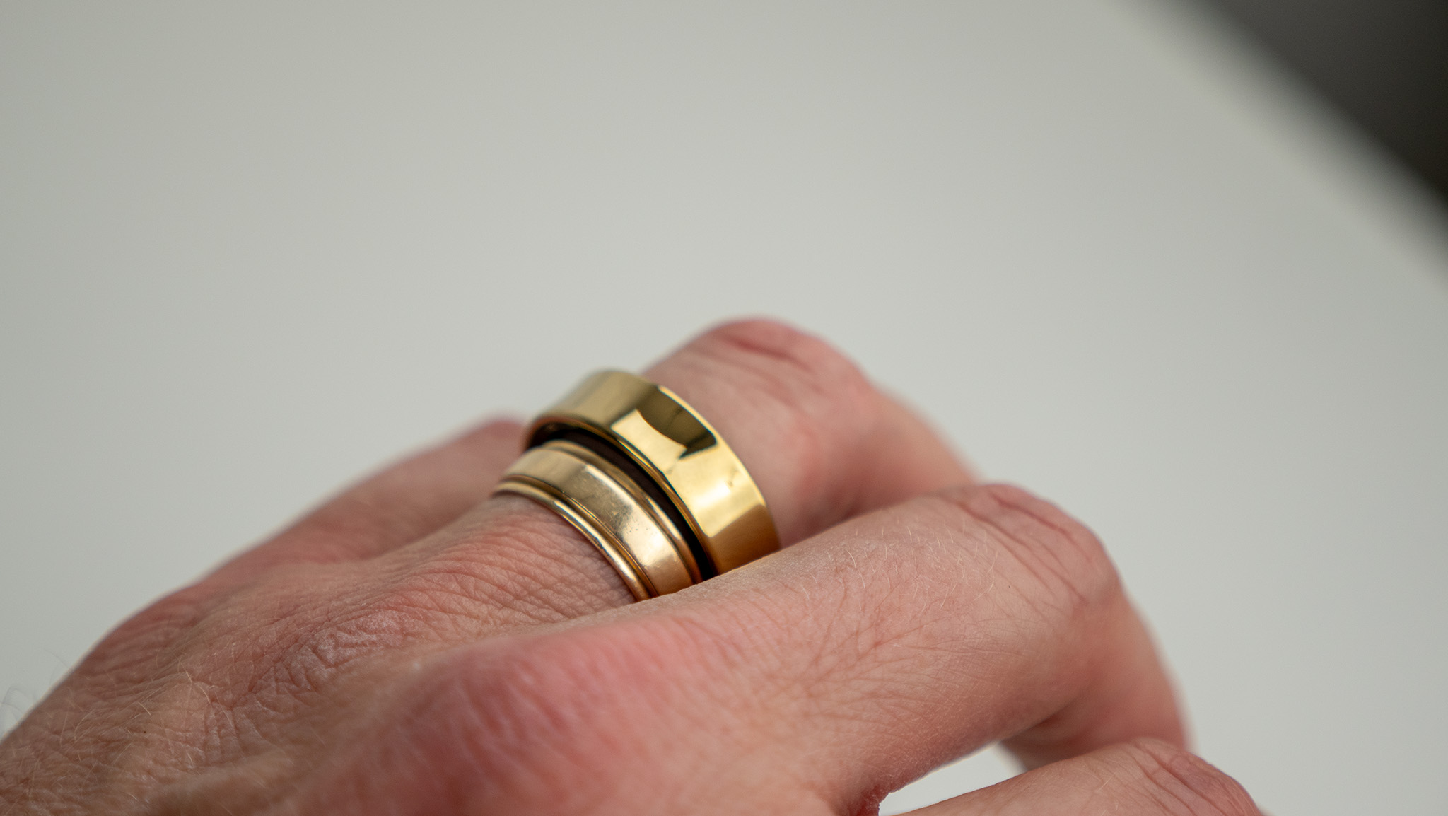 Comparing the gold Samsung Galaxy Ring with a gold wedding band