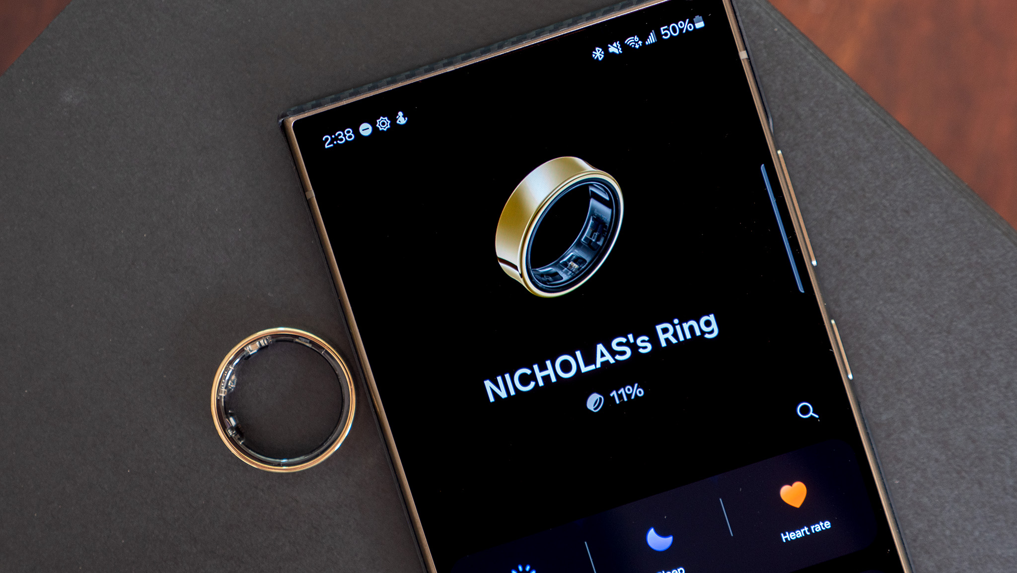 The gold Samsung Galaxy Ring showing battery percentage on the Samsung Wearables app