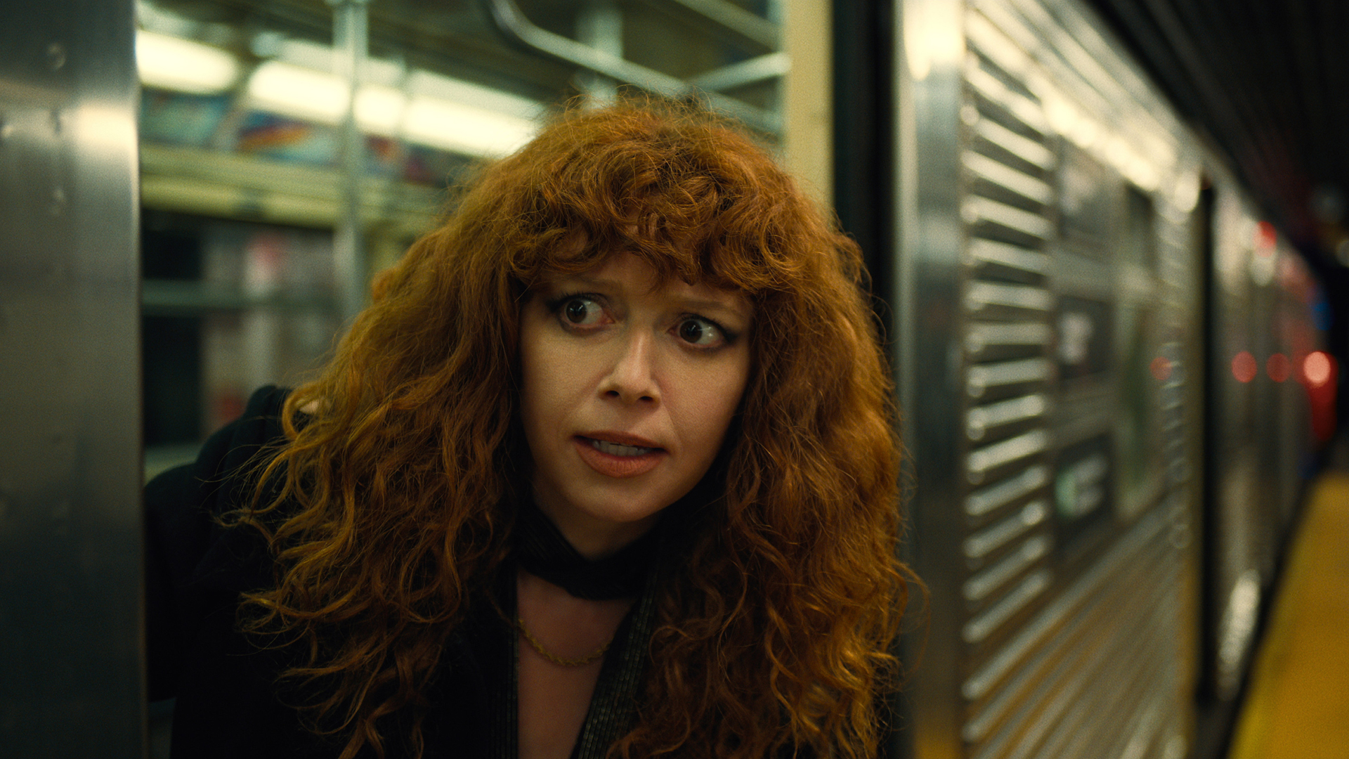 Natasha Lyonne's Nadia looks shocked as she board a subway train in Russian Doll season 2