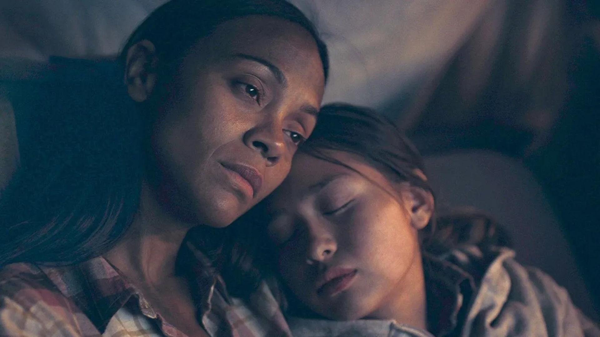 Zoe Saldana leans her head on a little girl in The Absence of Eden