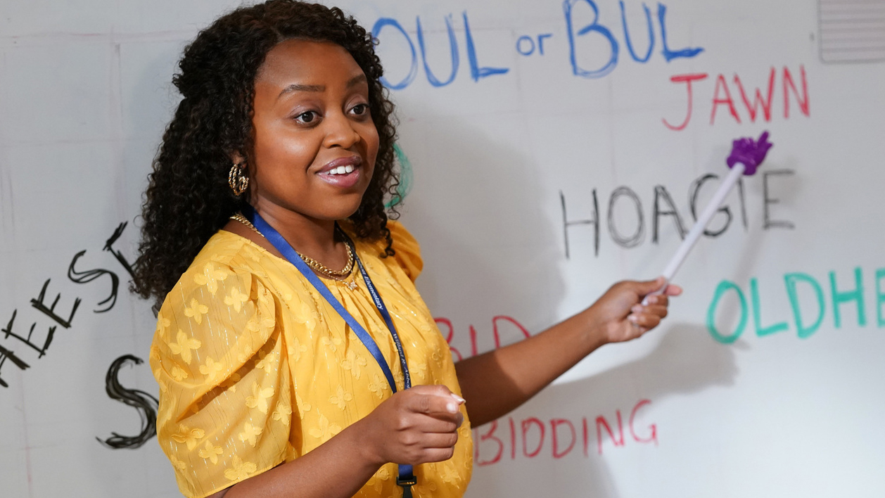 Janine pointing at a word on the whit board in Abbott Elementary.