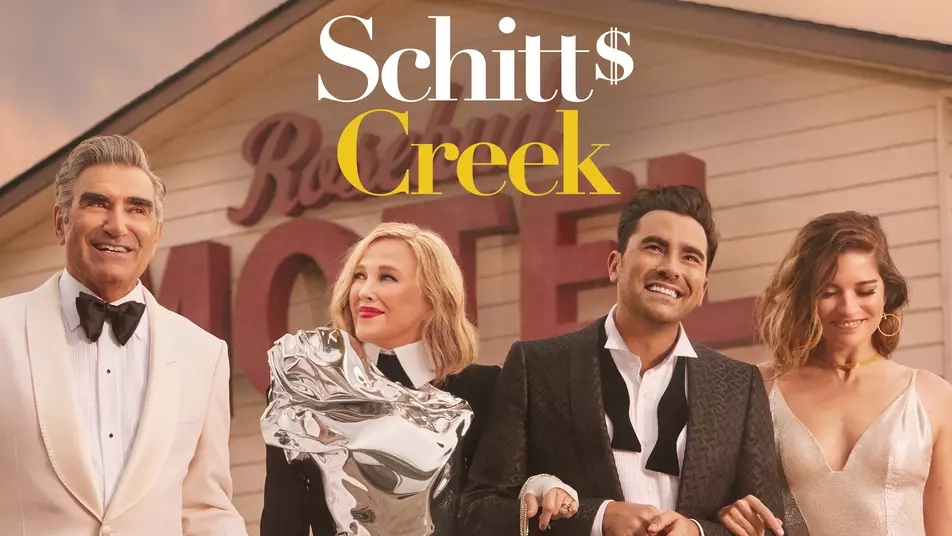 Johnny, Moira, David and Alexis laughing while linking arms in Schitt's Creek.