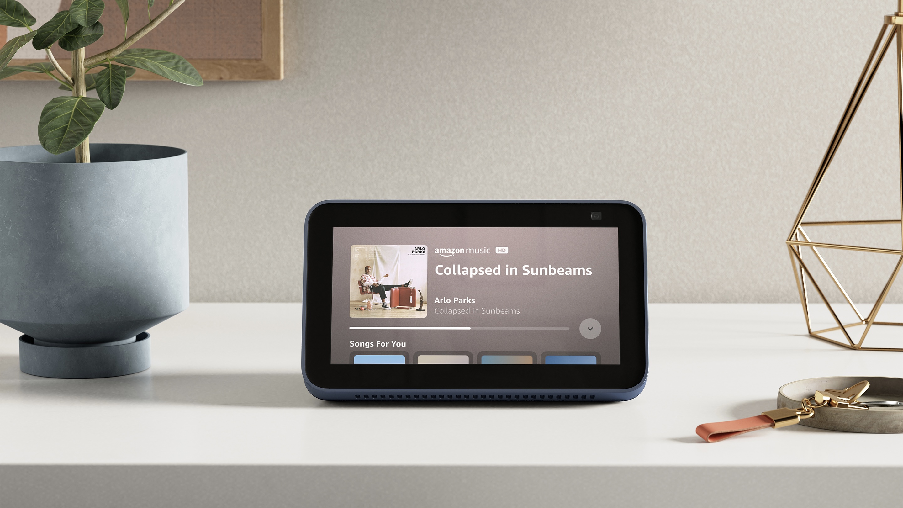 Amazon Echo Show 5 playing music on a desk