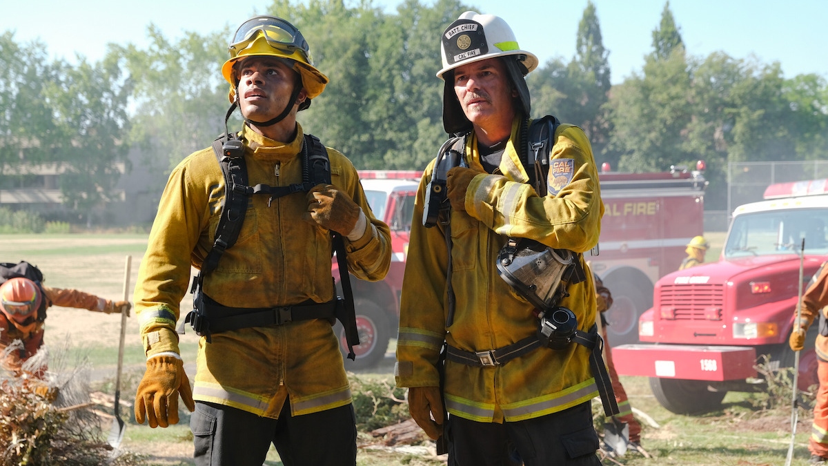 Jake and Vince in firefighter uniforms looking shocked at something off camera.