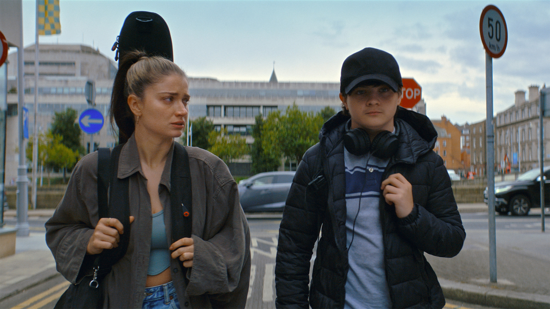 Eve Hewson carries a guitar through Dublin with screen son Orén Kinlan.