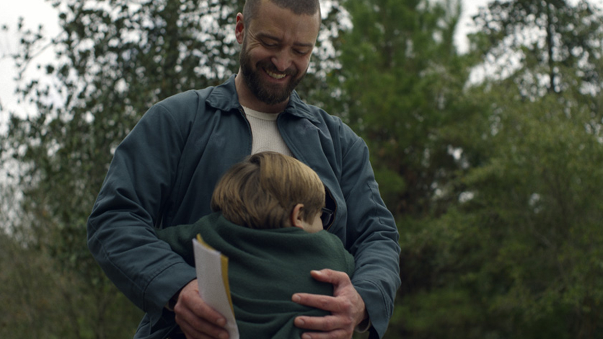 A man holds a child in his arms