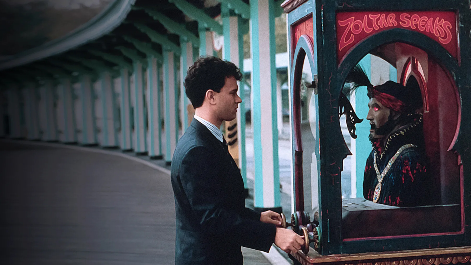 A man stands in front of a robot fortune teller stand