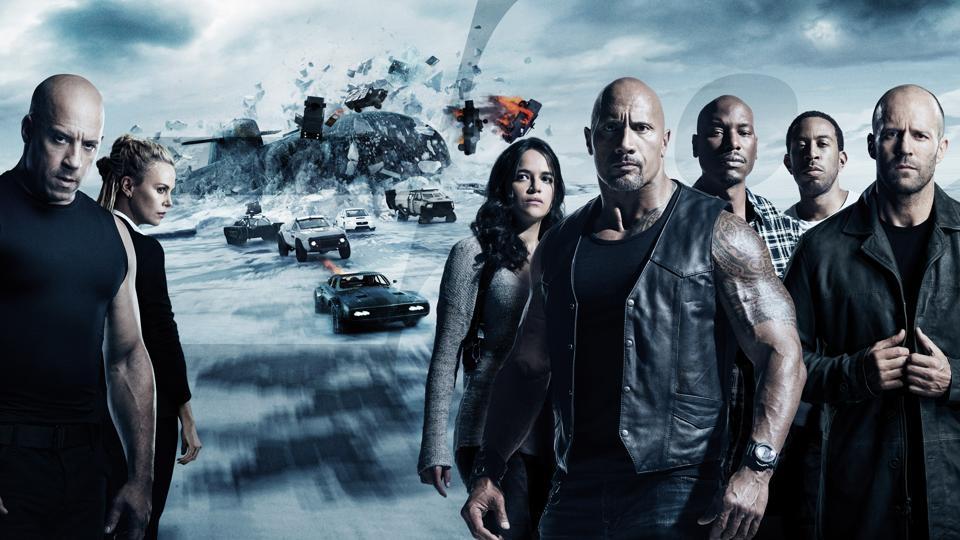 The Fate of the Furious cast in front of some icy car carnage