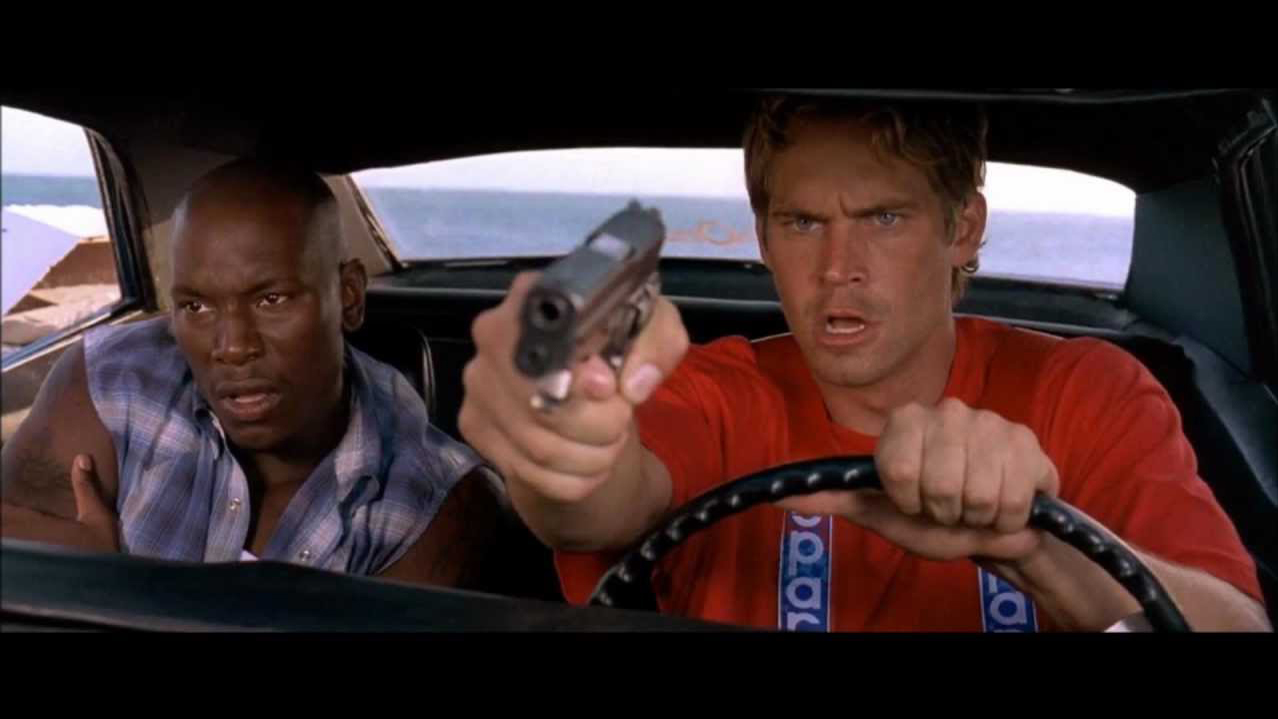 A still from the movie 2 Fast 2 Furious of two characters in a car, for the guide how to watch the Fast and Furious movies in order