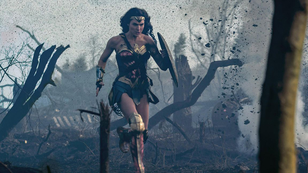 Gal Gadot running across a battlefield in Wonder Woman