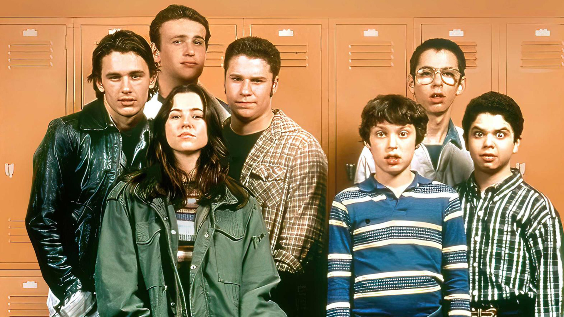 The cast of Freaks and Geeks stand in front of high school lockers