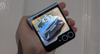 The Samsung Galaxy Z Flip 6 fully folded with a car background on the exterior display