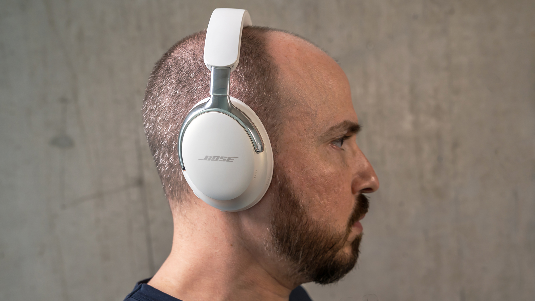 Side view of the Bose QuietComfort Ultra headphones being worn.