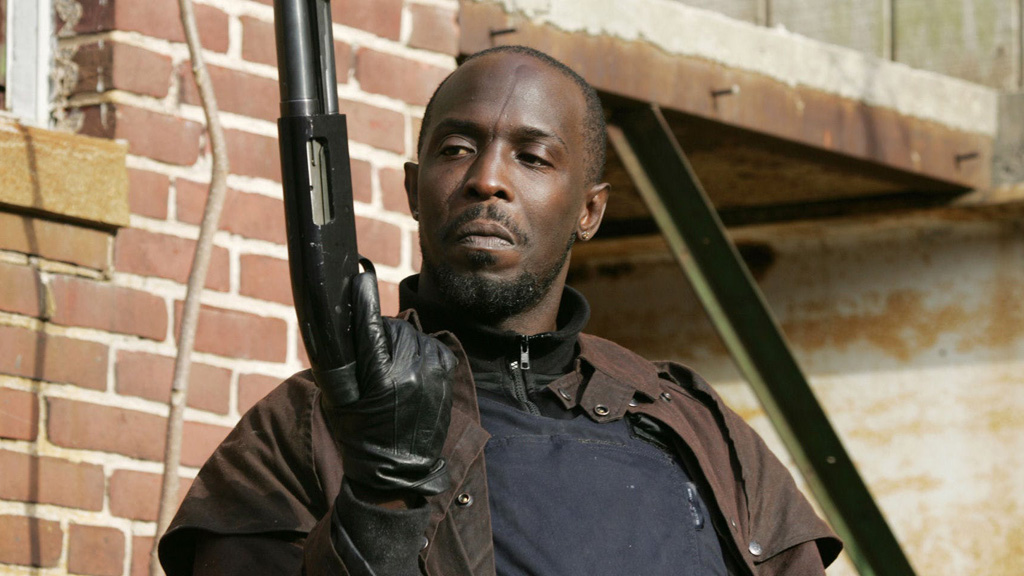 Omar Little wields a shotgun in a screenshot from The Wire