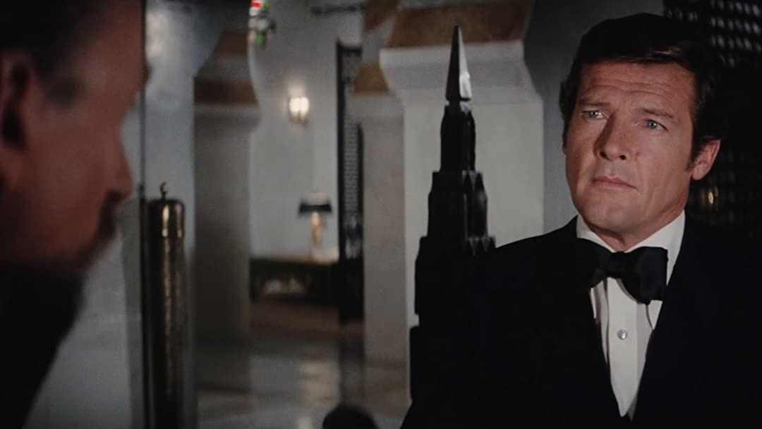 James Bond wears a tuxedo and chats to another character in The Spy Who Loved Me