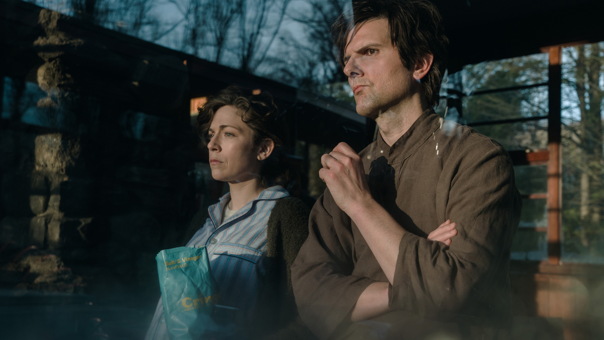 Mark looks out of a window alongside a woman in Severance season 1