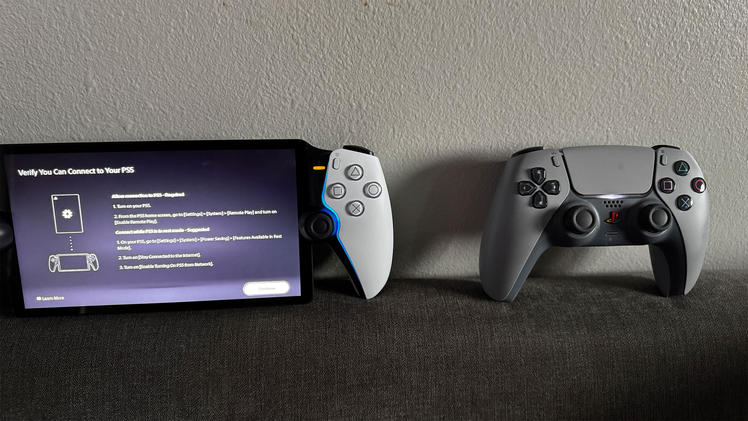 The PlayStation Portal placed alongside a PS5 controller.