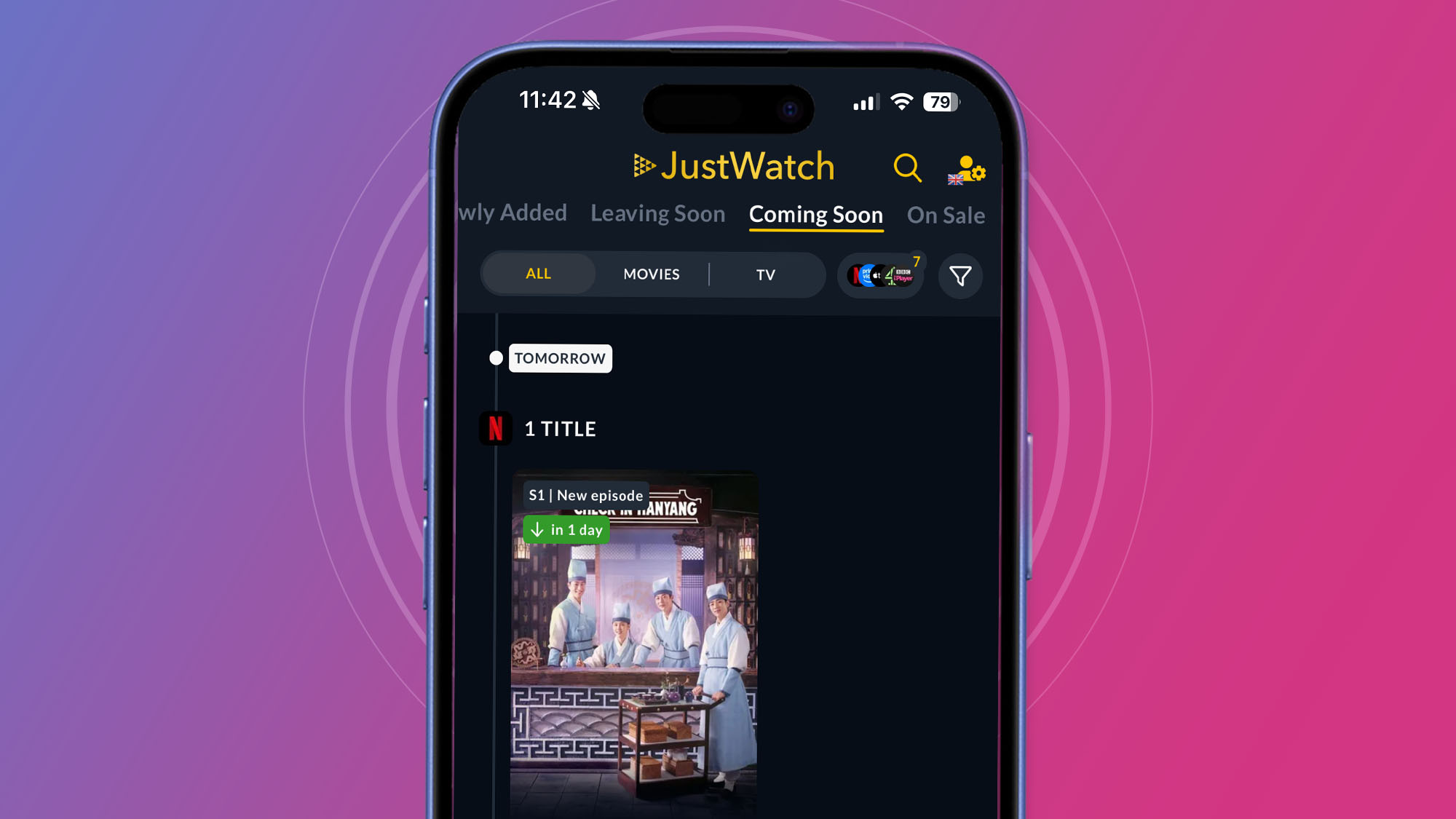 An iPhone on a purple and pink background showing the JustWatch app