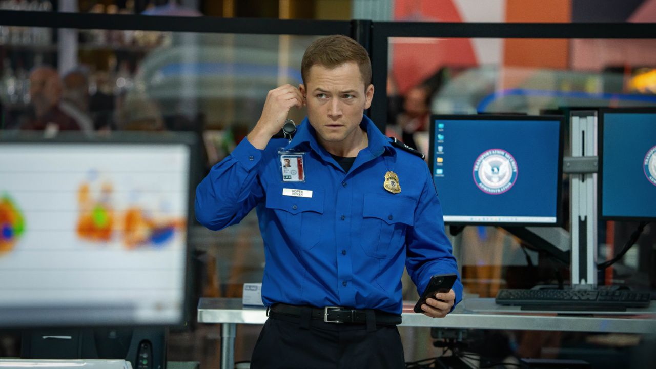 Taron Egerton's Ethan puts in an earpiece in Netflix's Carry-On movie