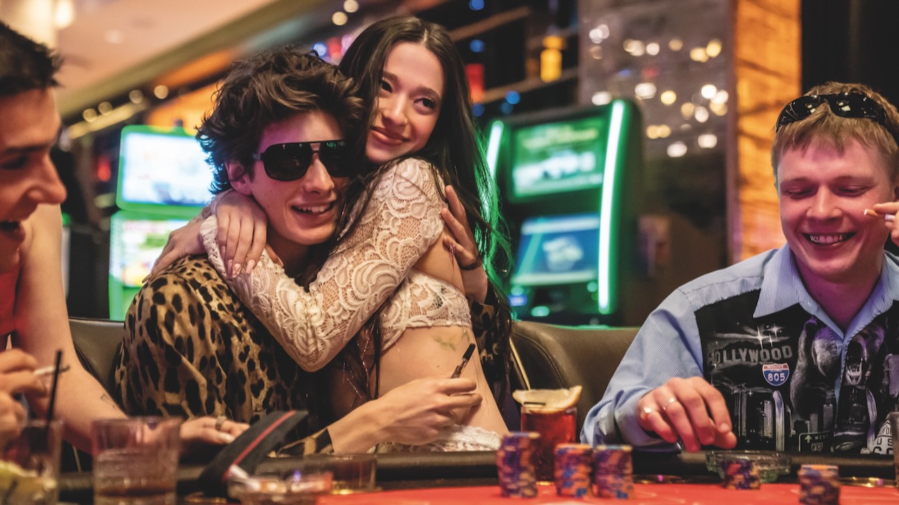 Anora sitting on Ivan's lap in a casino in her self-titled film