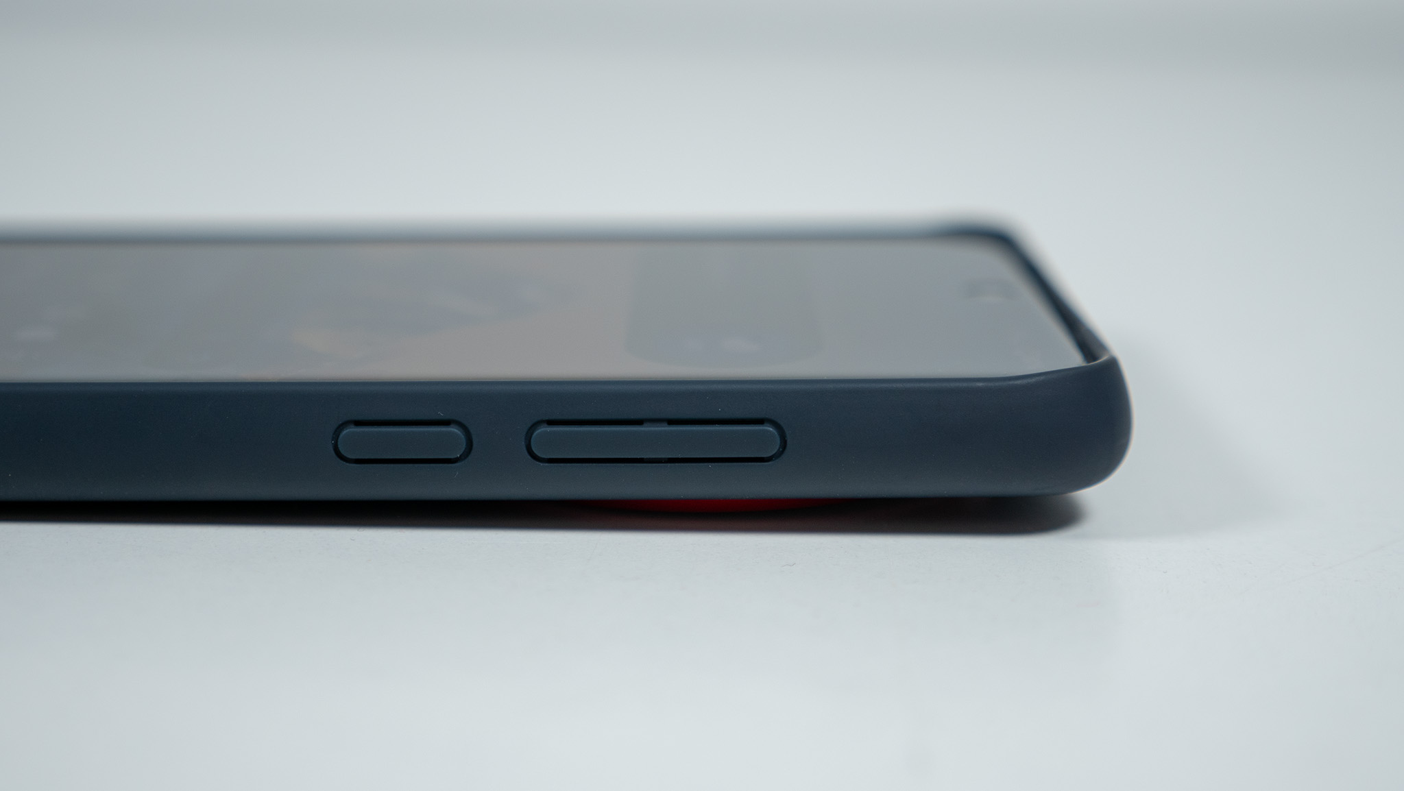 The button side of the official blue OnePlus 13 soft case