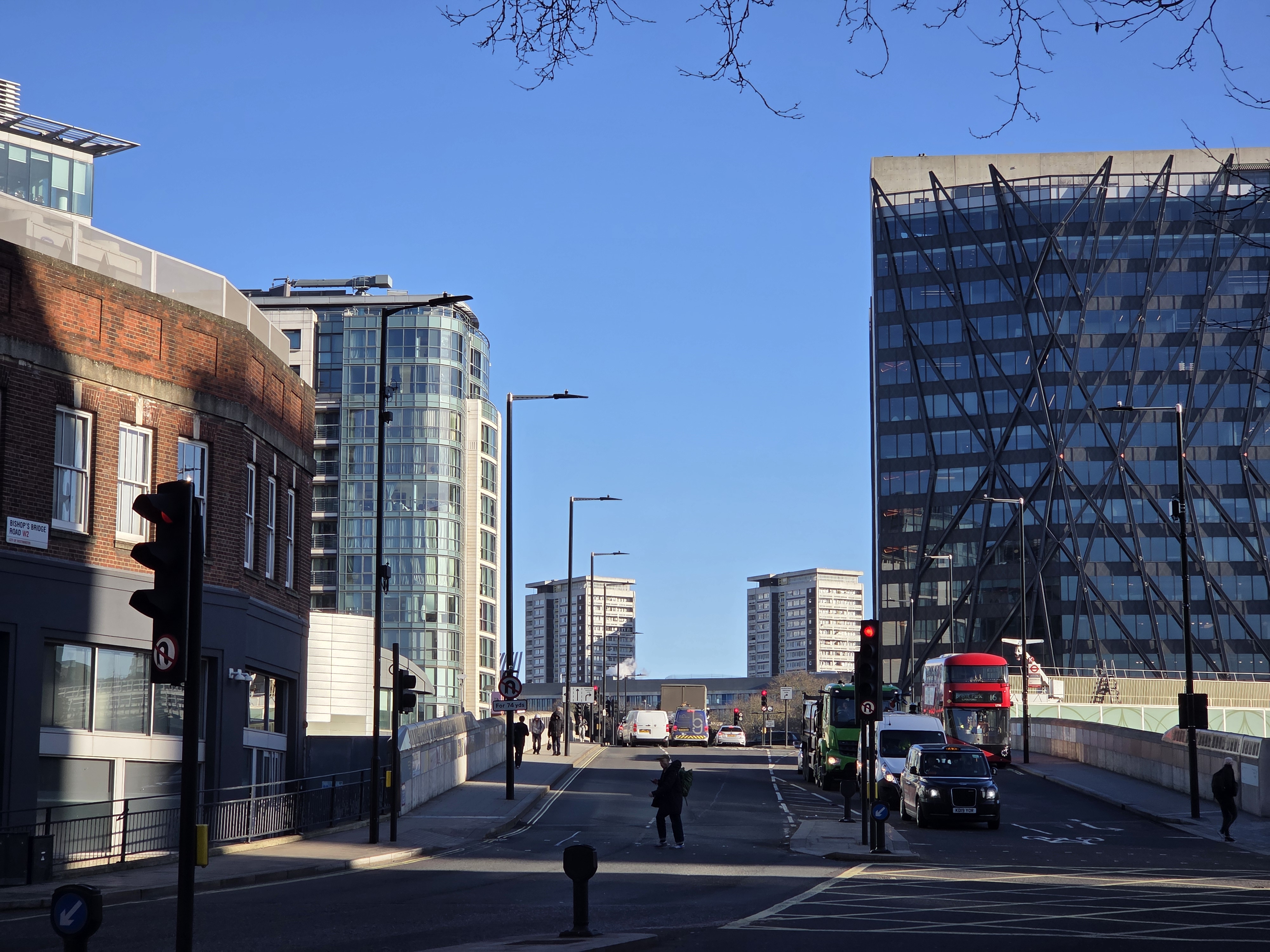 A street scene with office blocks, and a road with some traffic