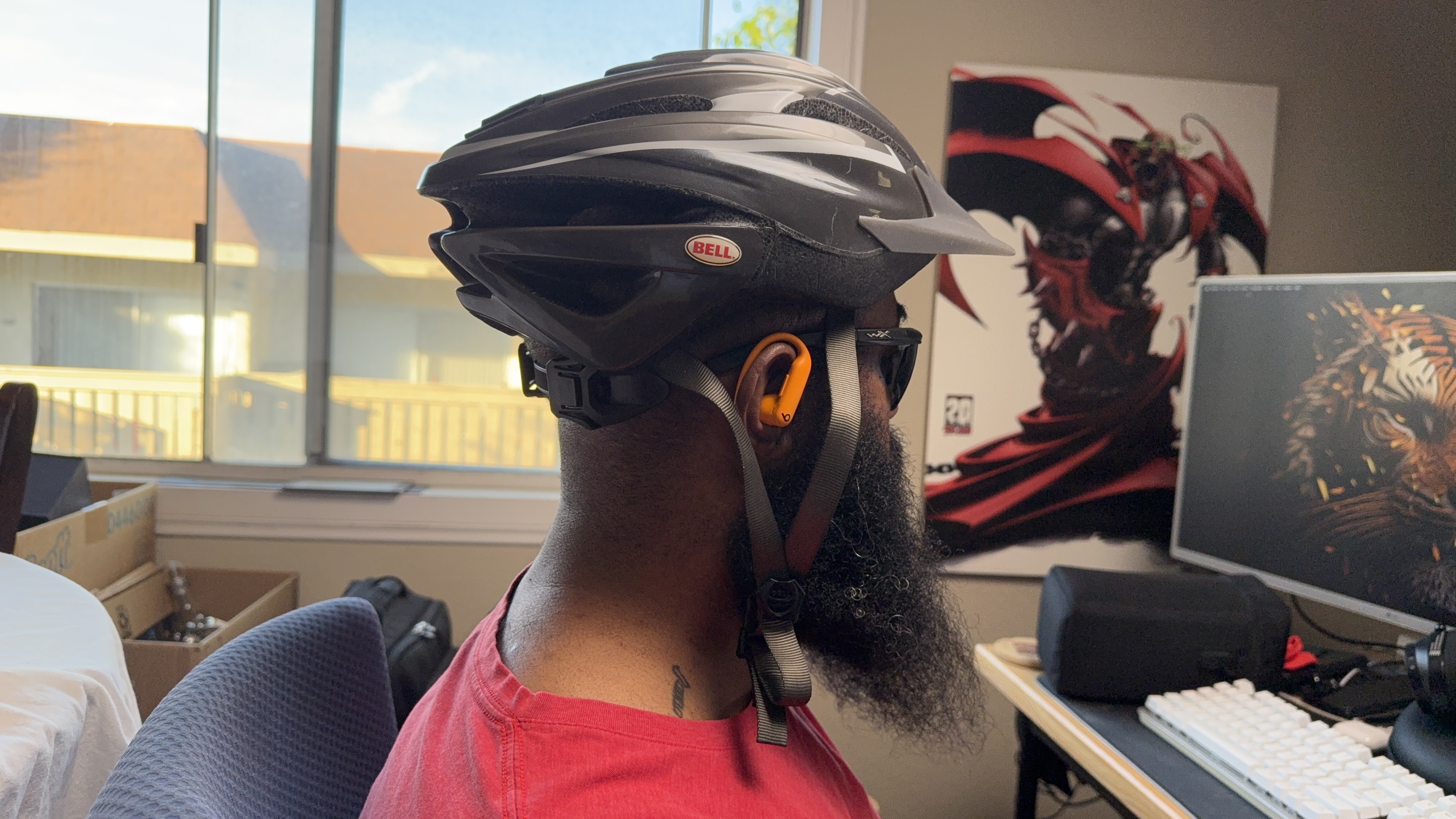 Powerbeats Pro 2 showing how they fit under a bike helmet and with sunglasses on