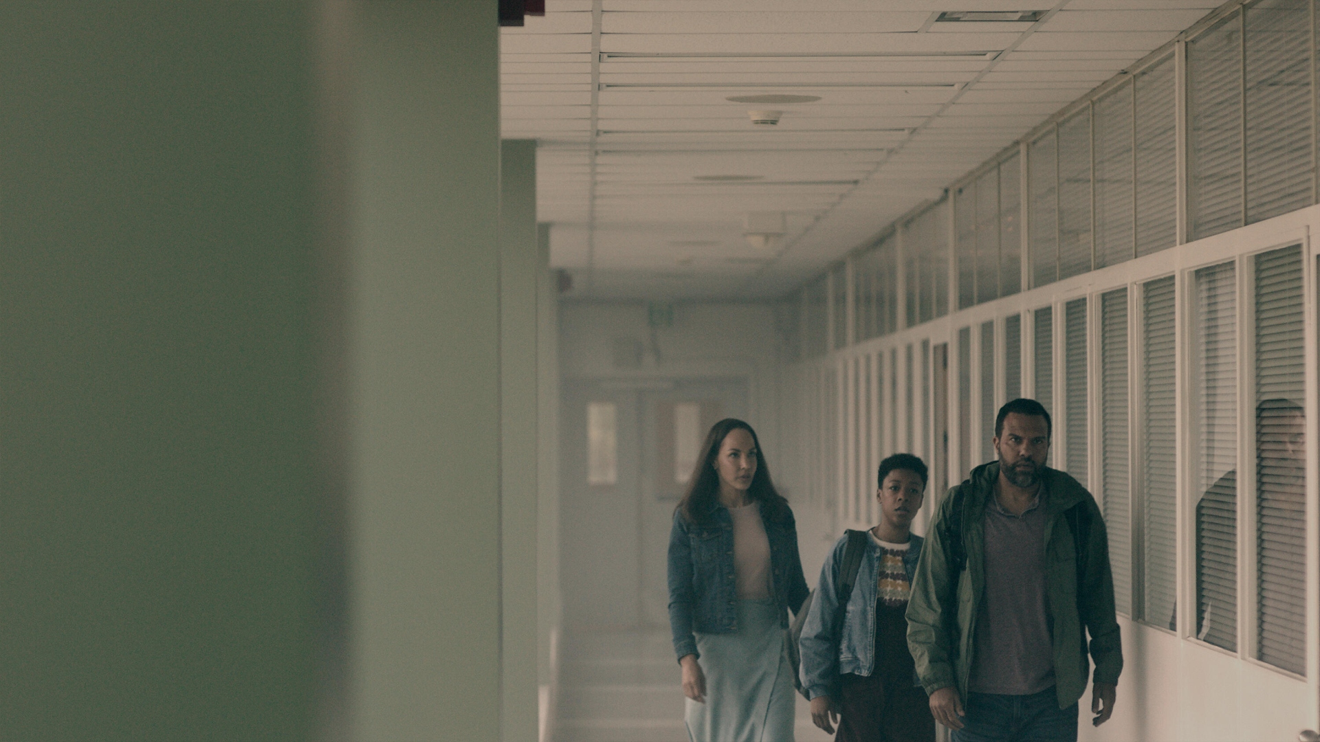 Luke, Moira, and Rita walk down a corridor in The Handmaid's Tale season 6