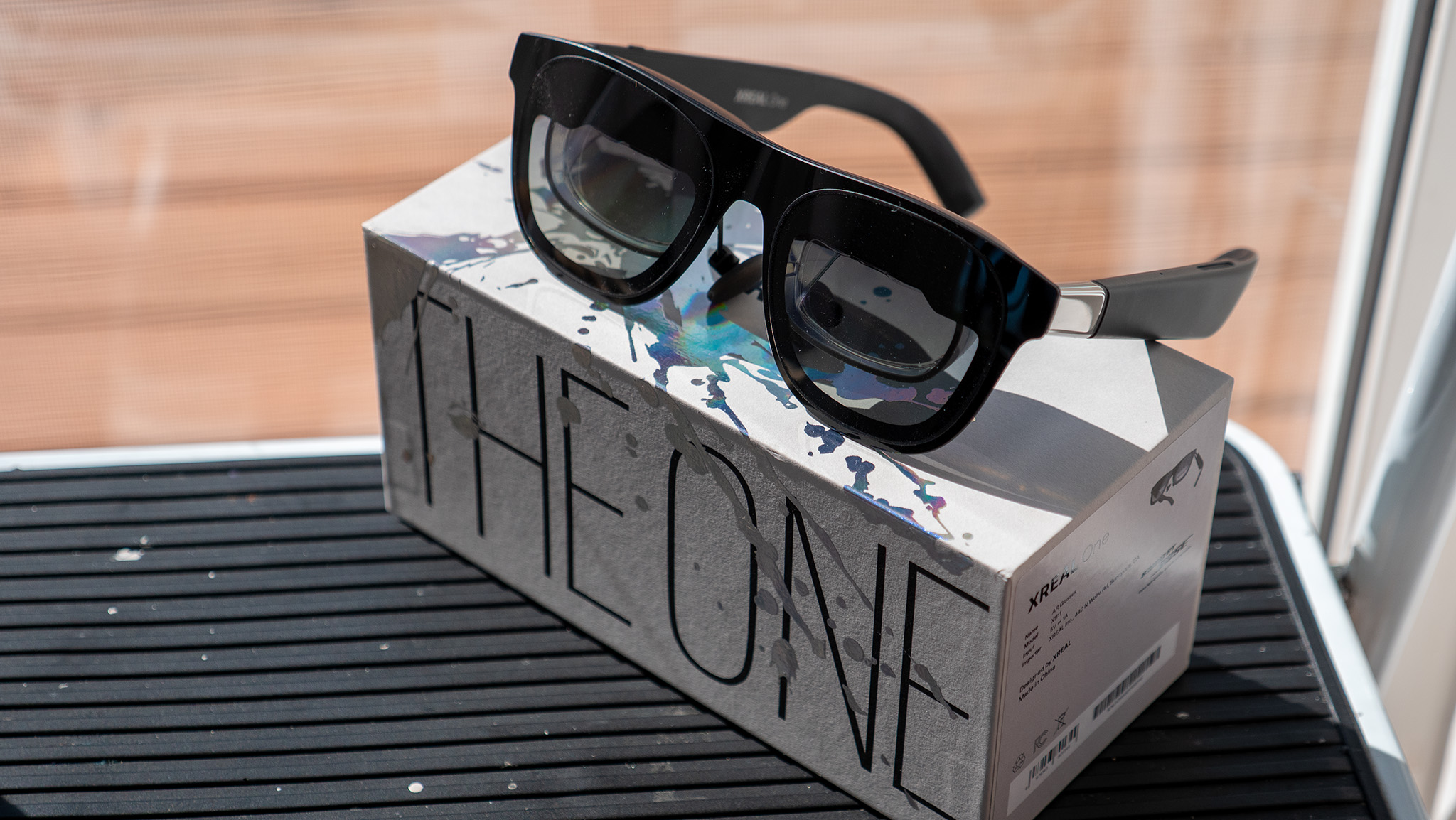 A pair of Xreal One smart glasses on its retail box