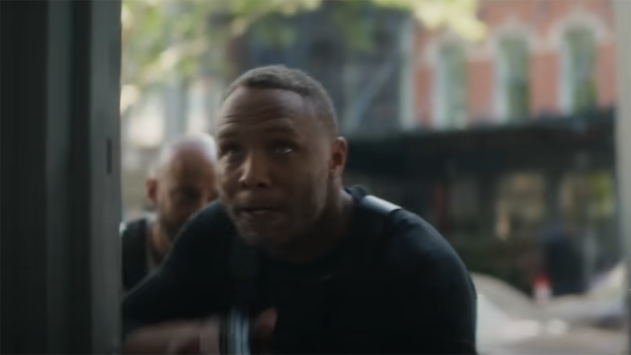 Cole North entering a building with his handgun raised in Daredevil: Born Again