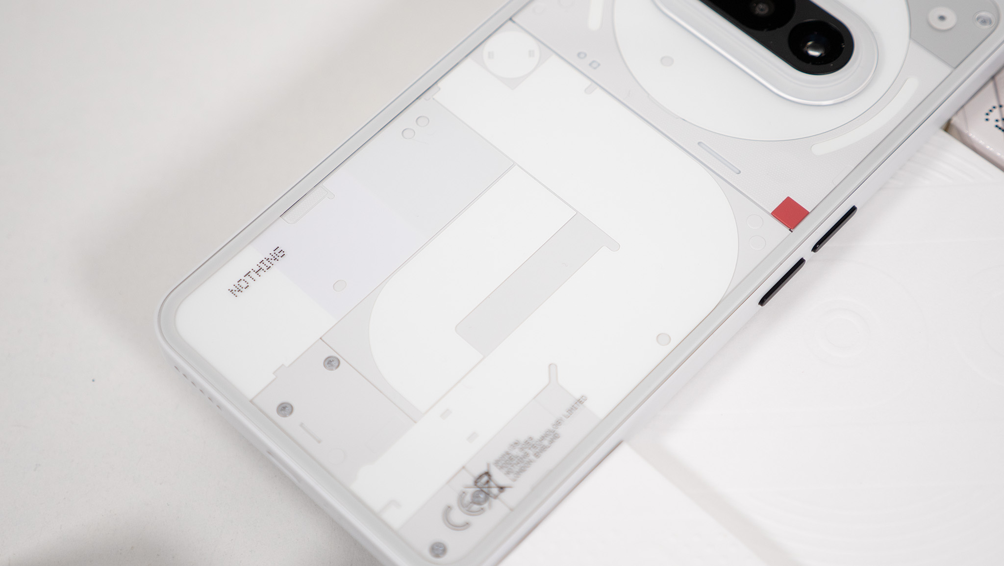 The transparent back of the white Nothing Phone (3a)