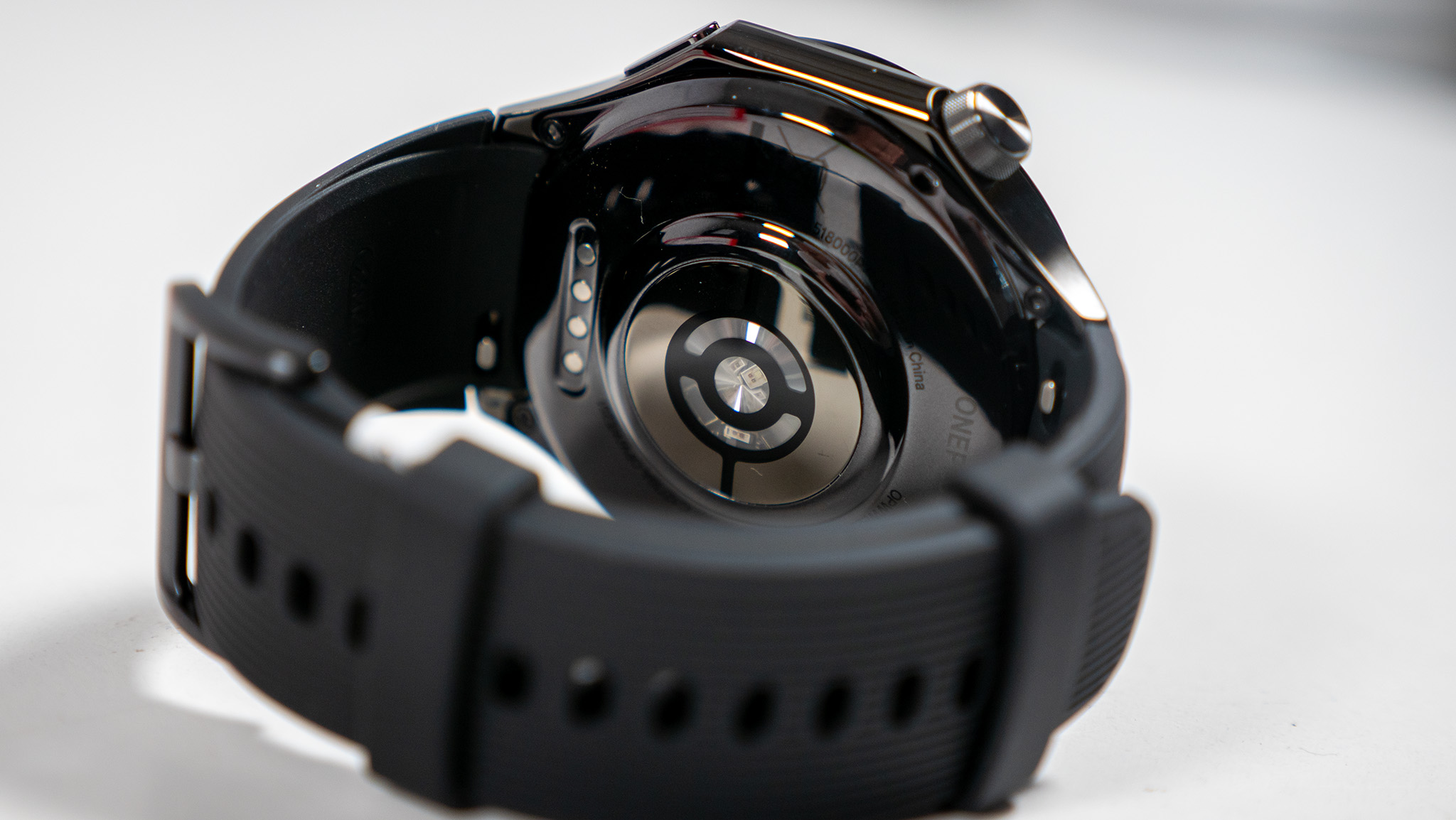 A close-up of the OnePlus Watch 3 from the underside with its strap fastened