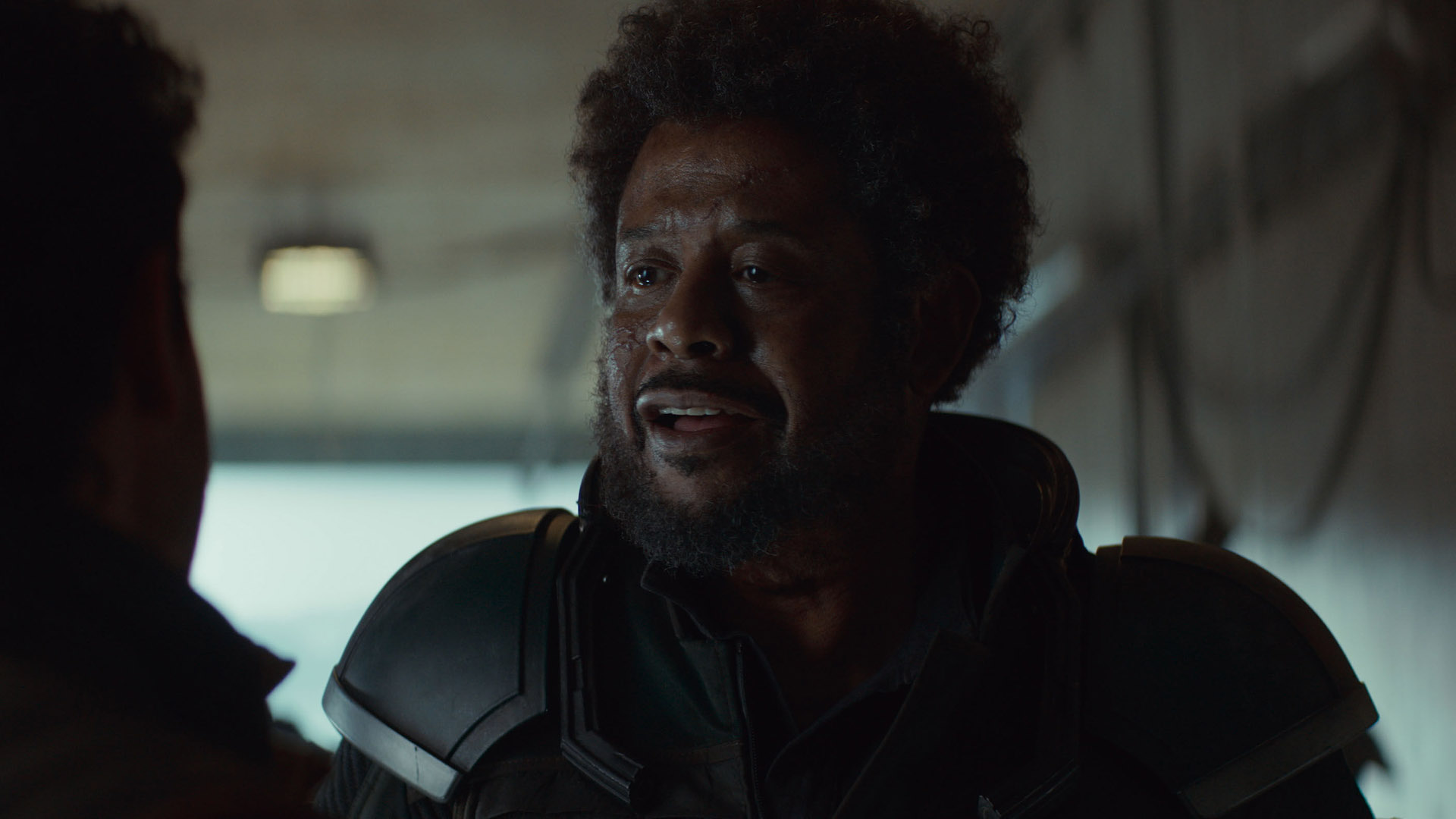 A close up of Saw Gerrera talking to a slightly off-camera Wilmon in Andor season 2